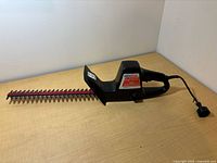 Full view of ServiStar hedge trimmer showing blade, body, and power cord