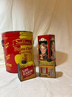 Front view of all four tins showing graphics and shapes
