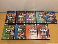 Front view of nine Sims 2 game cases