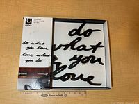 Front of box showing Umbra Mantra Wall Decor set and words inside