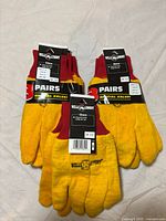 Front view of two sealed 3-pair packs and additional pair, tags visible