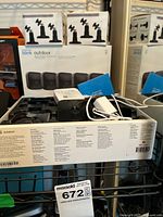 Open box showing one camera, cable, power adapter, and additional boxed accessories