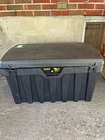 Full view of black plastic Contico storage chest with closed lid