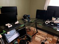 Full view of L-shaped glass desk with black metal frame