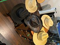 Overhead view showing all five cowboy hats of different materials and colors