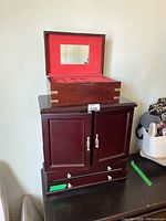 Both jewelry boxes stacked; cabinet below, smaller box on top