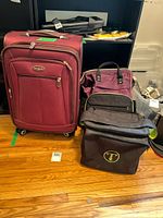 Front view of suitcase, backpack and shoulder bag