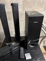 Front view of all speakers and remote on table