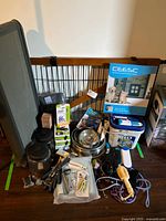 Overview of lot showing gate, pet door box, litter tray, bowls and accessories