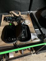 PSP console in case with charger and loose UMD on table