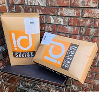 Two cardboard retail boxes with Intelligent Design branding