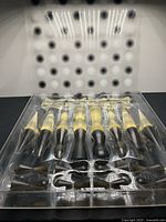 Tray showing all smoked and clear chess pieces inside packaging