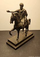 Right-front view of bronze equestrian statue on plinth