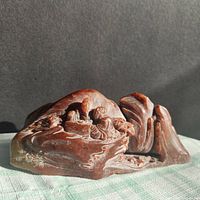 Full view of carved stone showing overall form and coloration