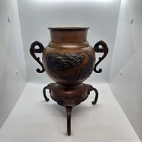 Front view showing handles, body, and legs of bronze censer