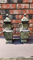 Front view of both bronze lidded dragon vases
