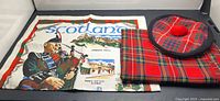 Overall view of tea towel, tartan scarf and tam hat