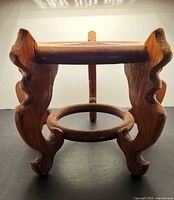 Front view showing overall form, carved legs and stretcher