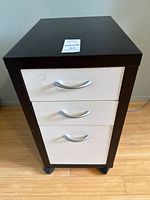 front view of cabinet showing three drawers and handles