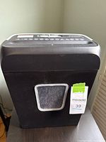 Front view of Bonsaii shredder showing bin and MaxSold tag