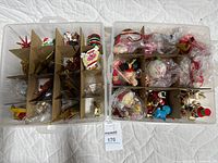 two sectioned plastic boxes filled with assorted ornaments
