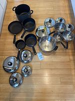 Group shot of all Circulon and Revere Ware cookware pieces and lids