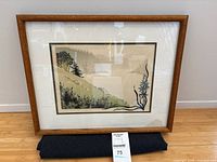 Front view of framed landscape print in wood frame