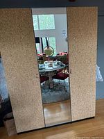 Wardrobe front view with cork doors and mirrored center door