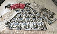 Complete eight-piece set laid out showing flat sheet, fitted sheet and six pillowcases in assorted patterns