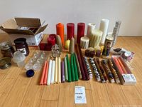 Full lot laid out showing variety of candles and holders