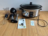 Full lot showing Cuisinart attachments and Farberware slow cooker
