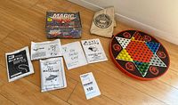 Overview of Magic Secrets kit papers, Chinese Checkers board, pegs and pouch