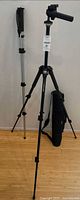 Tripod with mounted head, monopod, and carrying case