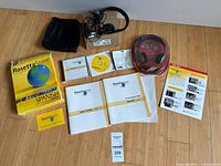 Full layout of kit contents including box, discs, books, headset, pouch, manuals