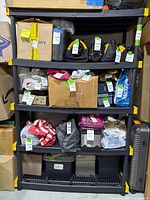 Front view of shelving unit loaded with boxes showing five shelves and yellow corner connectors