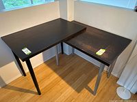 Both Linnmon tabletops assembled in L-shape on legs