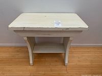 Front angled view of wooden bench showing top, curved supports, lower shelf