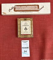 Both cribbage sets: cardboard-boxed wooden board and plastic board with cards