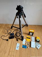 Group shot showing tripod, camera, printer, cables, paper and manuals