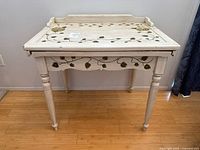 Front view of white wood desk with leaf design