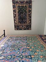 Coverlet pattern close-up with wall tapestry in view