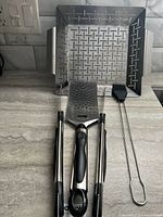 Overall lot showing tray, tongs, spatula and brush