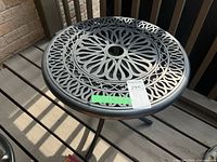 Top view showing floral cut-out design and umbrella hole