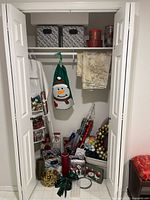 Full closet view with decorations, wrapping paper, bins and ornaments