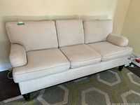 Front view of beige three-seat Norwalk sofa