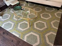 Full view of rug with geometric hexagon pattern under coffee table and sofa