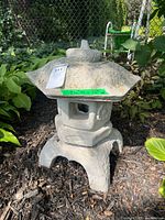 Front view of concrete garden lantern showing full structure and roof