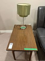 Top view of wood end table with lamp on surface