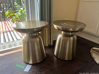 Both drum side tables near window