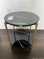 Full view of round side table showing top and lower shelf